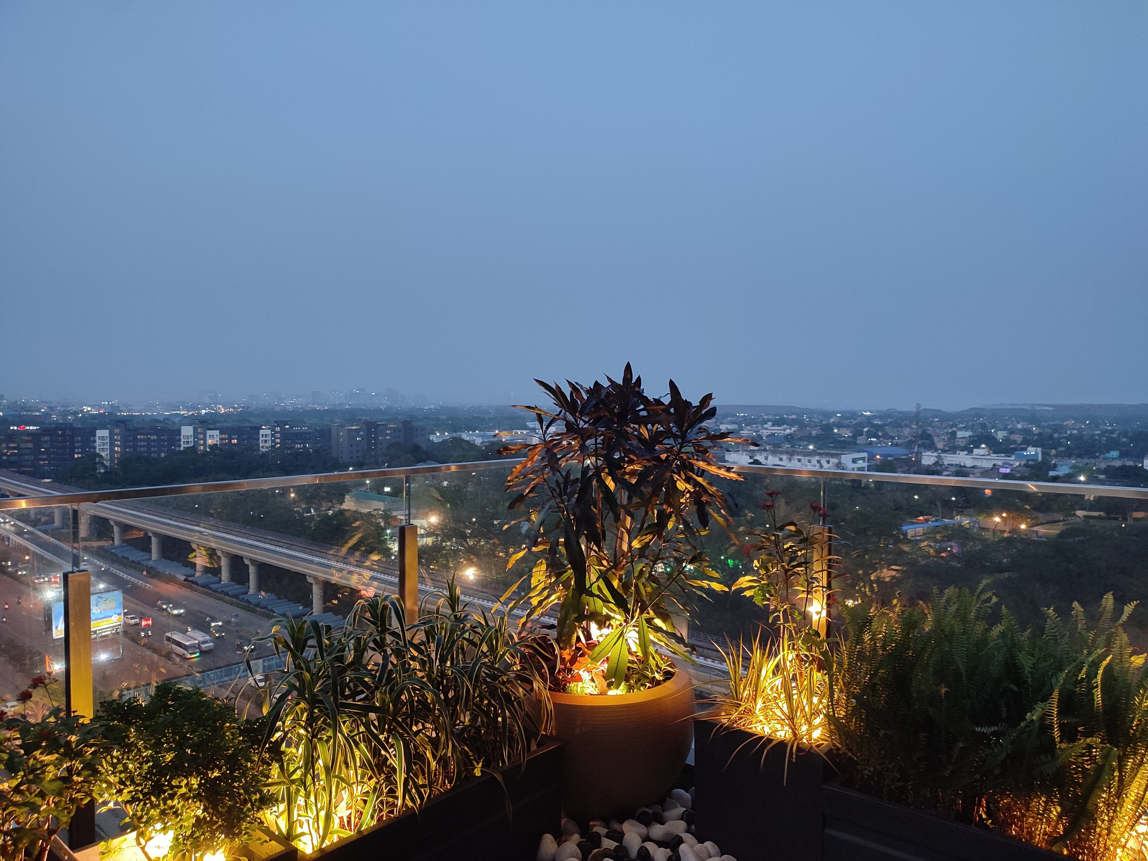 Grand terrace at dusk — LED uplights, Croton centrepiece, Kolkata skyline